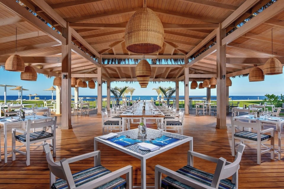 Dine under warm wood tones with ocean breezes nearby.