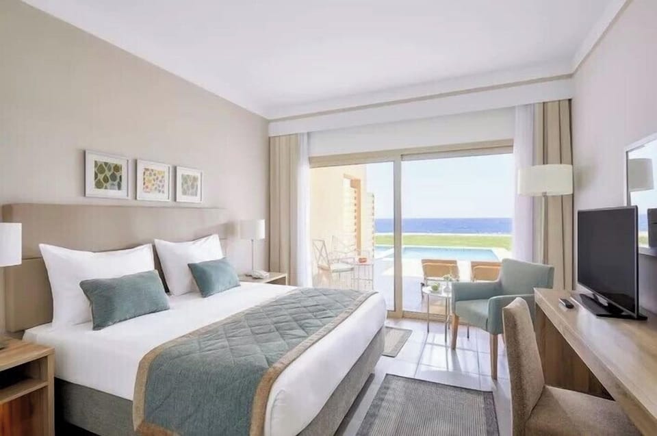 Sip morning coffee beside sliding doors and sparkling water views.
