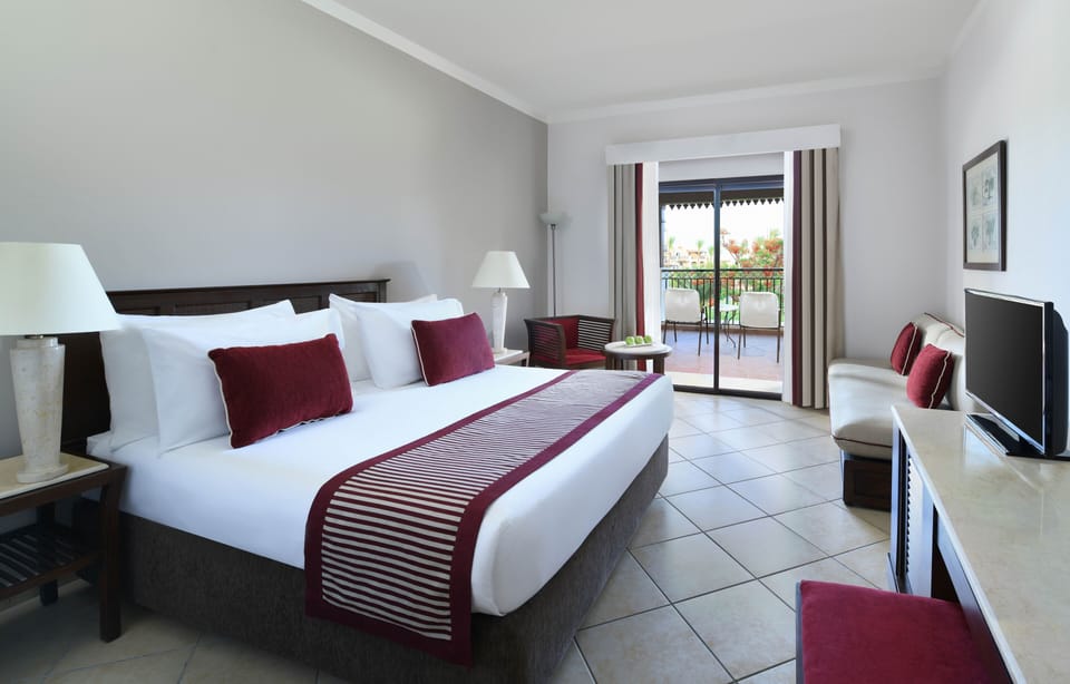 Unwind in crisp linens with balcony breezes and sunshine.