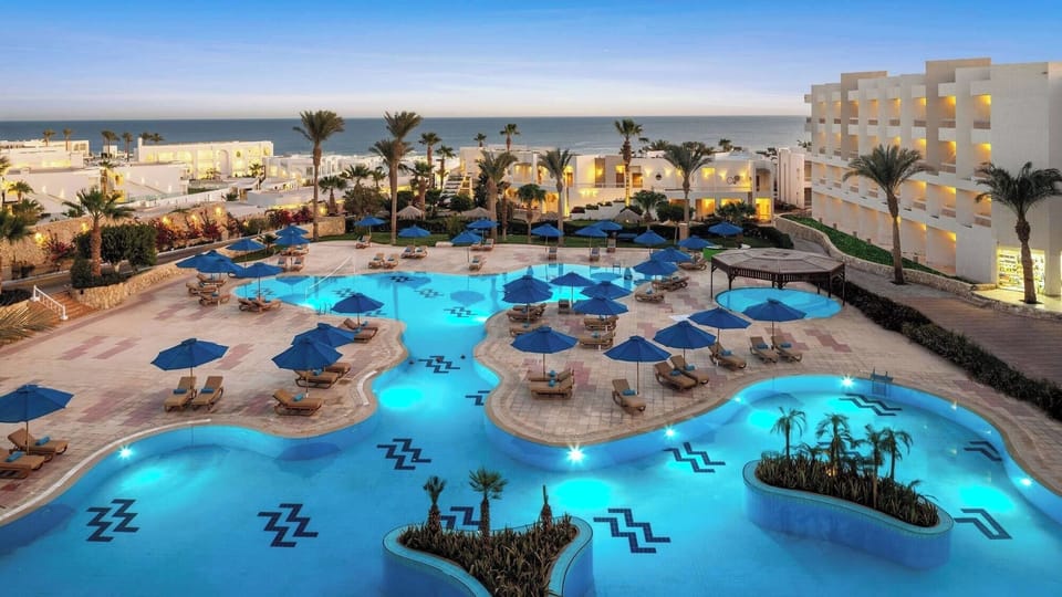 Explore sweeping resort pools and pathways leading toward the ocean.