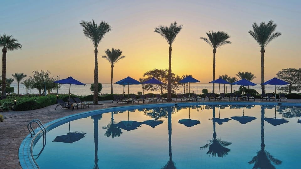 Catch the sunrise while you lounge poolside by the sea.