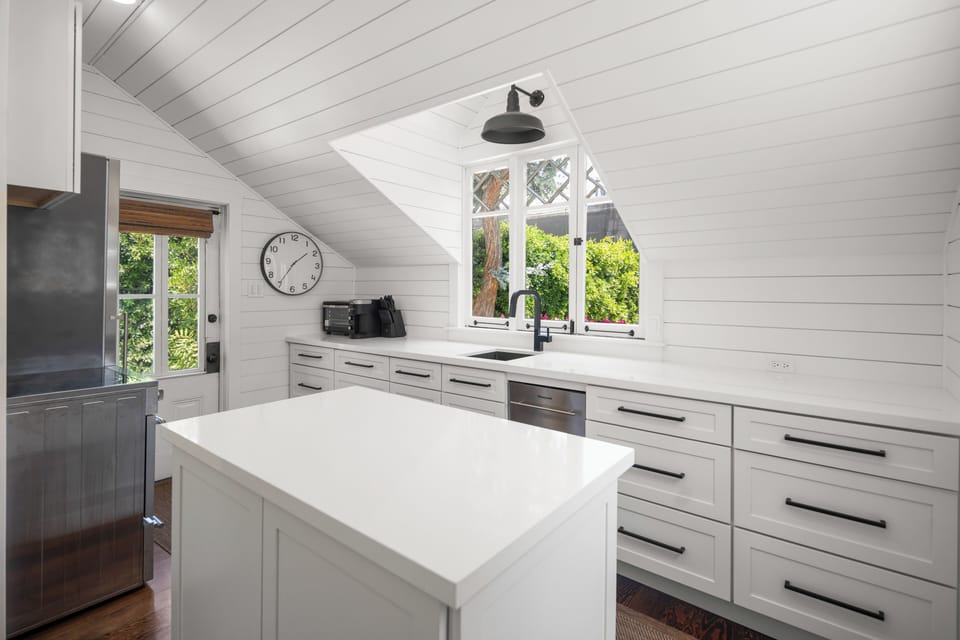 Kitchen with windows to backyard.