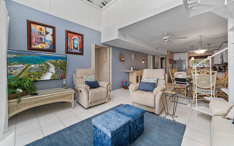 Comfortable living room with a spiral staircase leading up to the family loft space