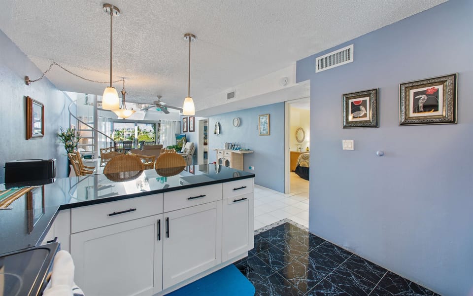 Open floor plan between the kitchen, dining, and living rooms