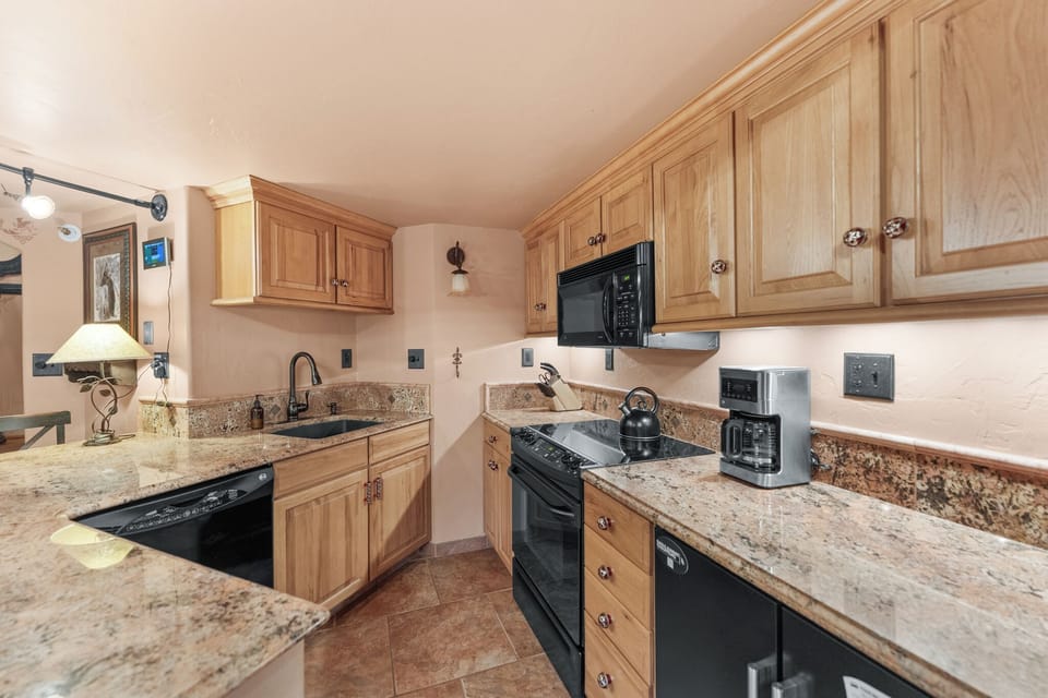 Full kitchen with a breakfast bar, seating 2.
