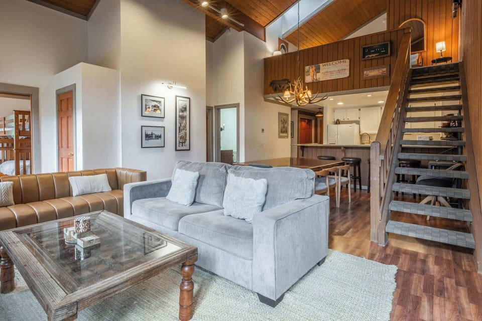 Cozy rustic living room w/ wood burning fireplace, smart TV, & full size sofa sleeper