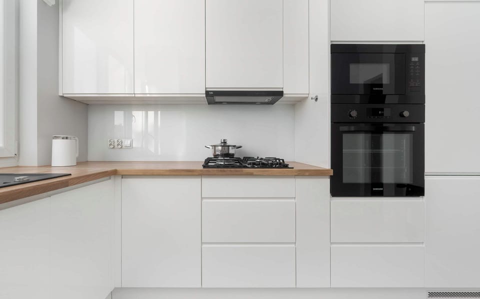 The sleek design of the kitchenette blending seamlessly with the living area.