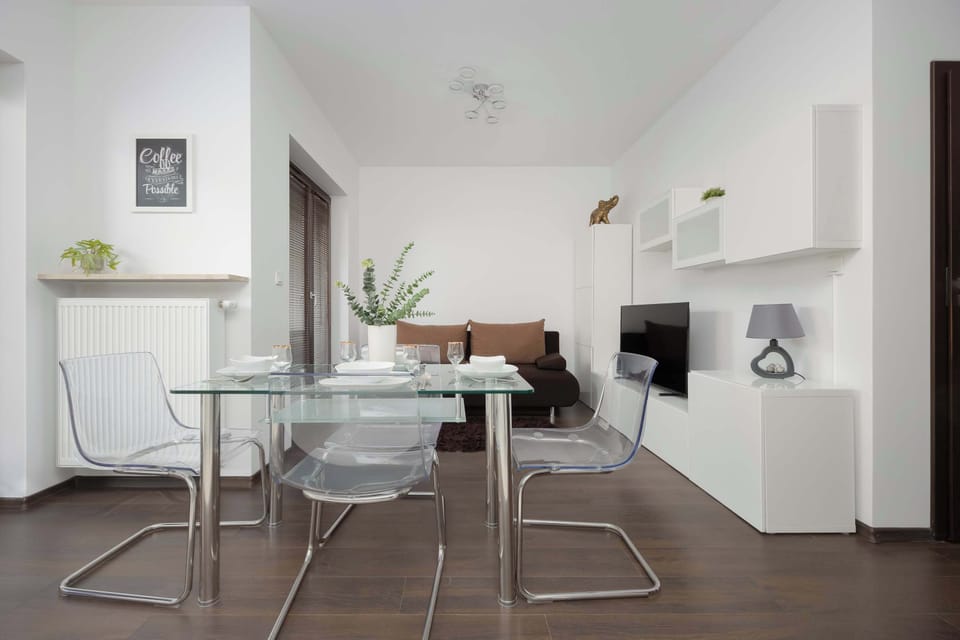 The clean, harmonious space with a dining table and TV is perfect for quality time and peaceful relaxation after a busy day.