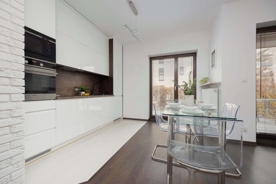 Large windows in the dining area let in plenty of natural light, making the space feel even more open and airy.