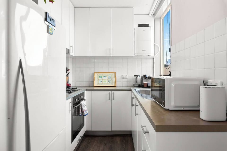 The compact yet efficient kitchen is thoughtfully equipped with a gas stove, oven, microwave, fridge, and Nespresso machine, making it ideal for simple meals or light breakfasts.