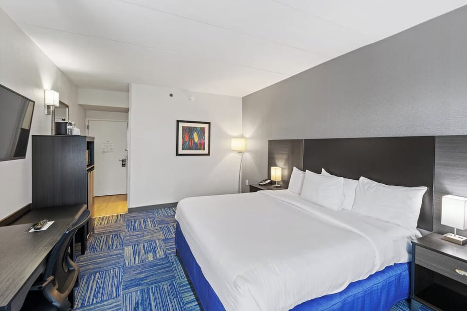Relax in a spacious king room with cozy bedside glow.