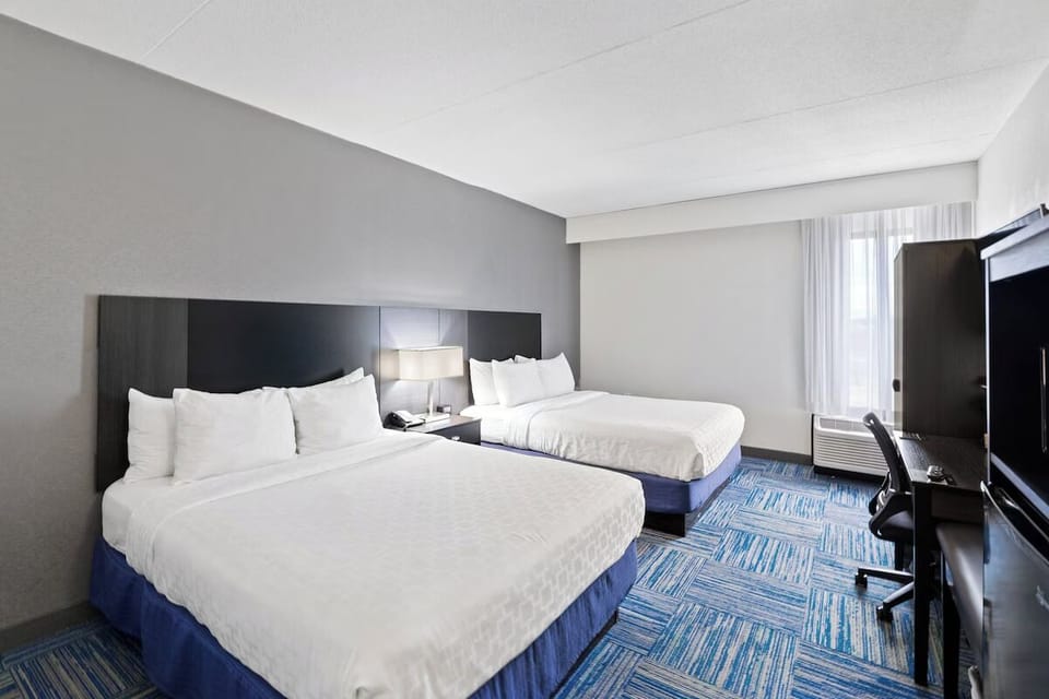 Recharge in a bright double room with plush, inviting beds.
