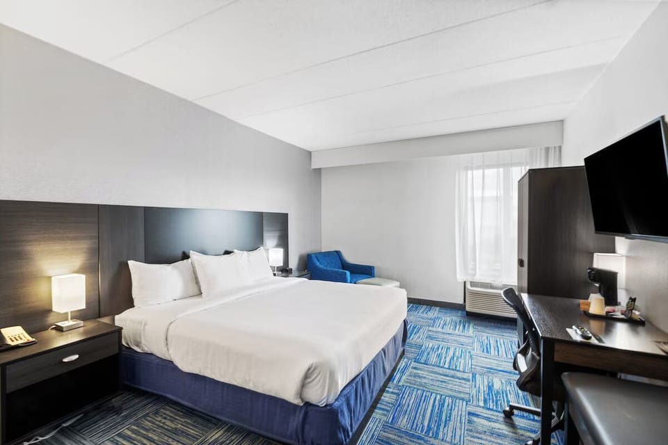 Settle into a crisp king bed in a sunlit room.
