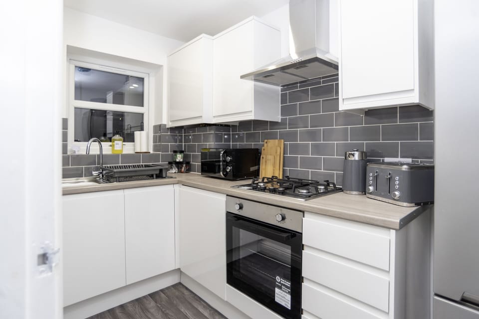 A clean, modern kitchen stocked with all appliances, utensils, and essentials for long stays.
