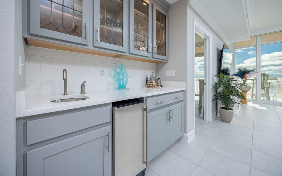Grab a chilled drink from the fridge or create your favorite cocktail at this stylish wet bar