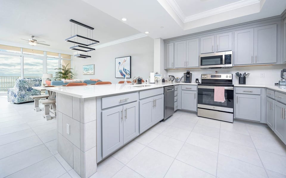 Prepare meals in this kitchen with elegant cabinetry, stainless appliances, and spacious countertops