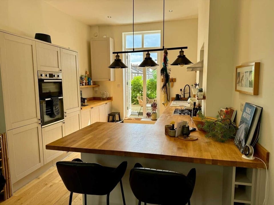 Kitchen with breakfast bar (also a great work space) leading out to the balcony. 