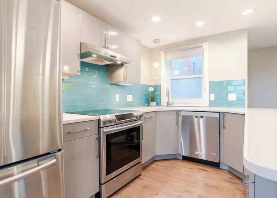 Modern kitchen with sleek design and vibrant tiles, perfect for joyful meal prep