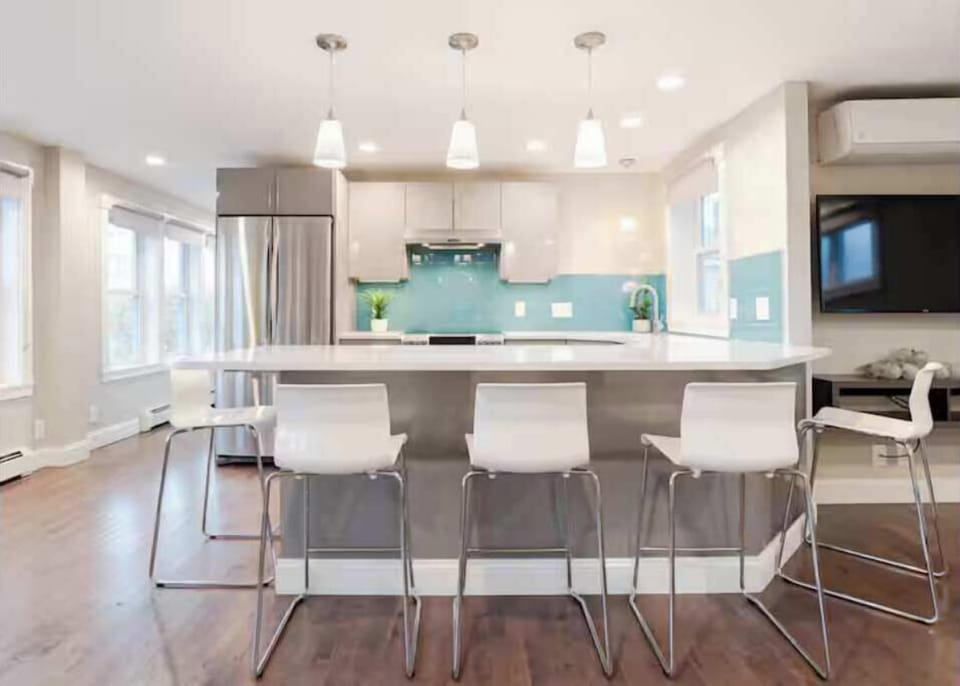 Kitchen paradise with sleek appliances and vibrant turquoise accents.