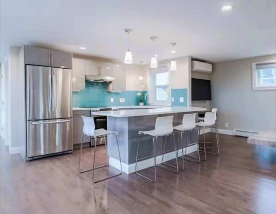 Sleek kitchen with vibrant backsplash, perfect for cooking and gatherings.