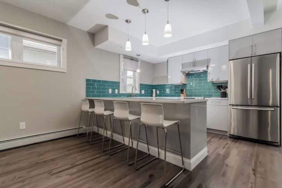 Kitchen oasis with sleek design and turquoise tiles for culinary adventures.
