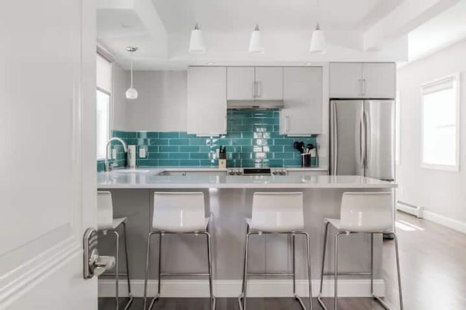 Gourmet kitchen with dazzling turquoise tiles, perfect for cooking feasts.
