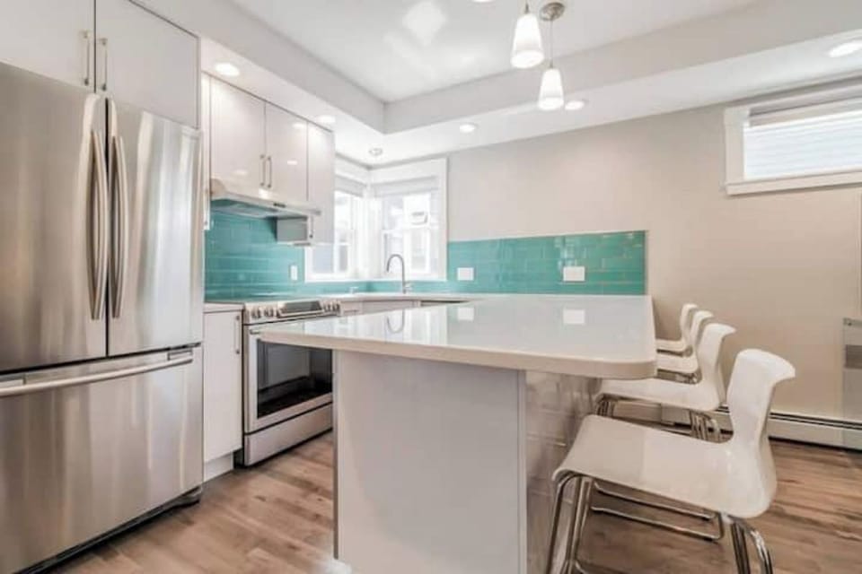 Kitchen: Bright, modern space with sleek appliances & vibrant teal accents!