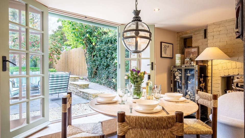 The dining area is alongside the sitting area, just next to French doors which open to the garden.