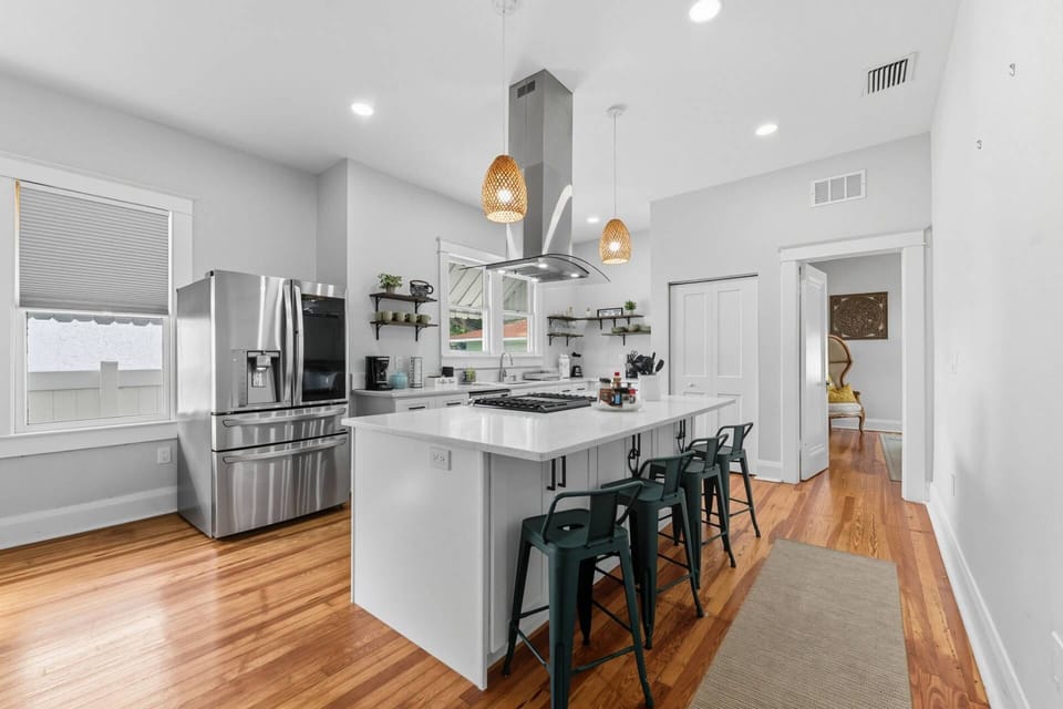 Bright and fully renovated kitchen with stainless steel appliances and gas range.