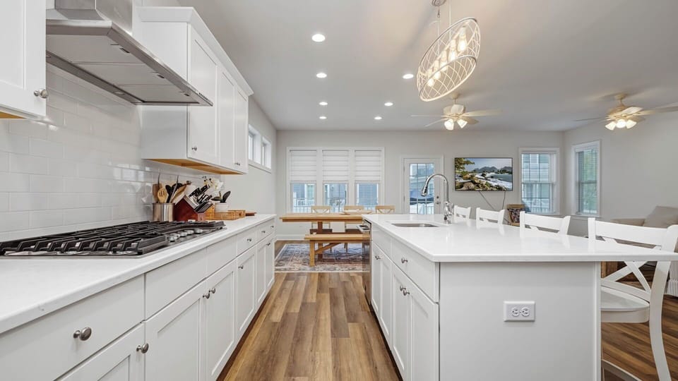 Bright, open-concept, fully stocked kitchen featuring a large center island with