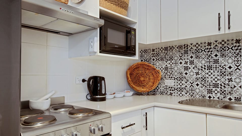 Fully equipped kitchen with stainless steel appliances.