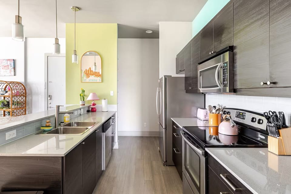 fully stocked kitchen with Keurig dual-system coffee pot, hot kettle, & more