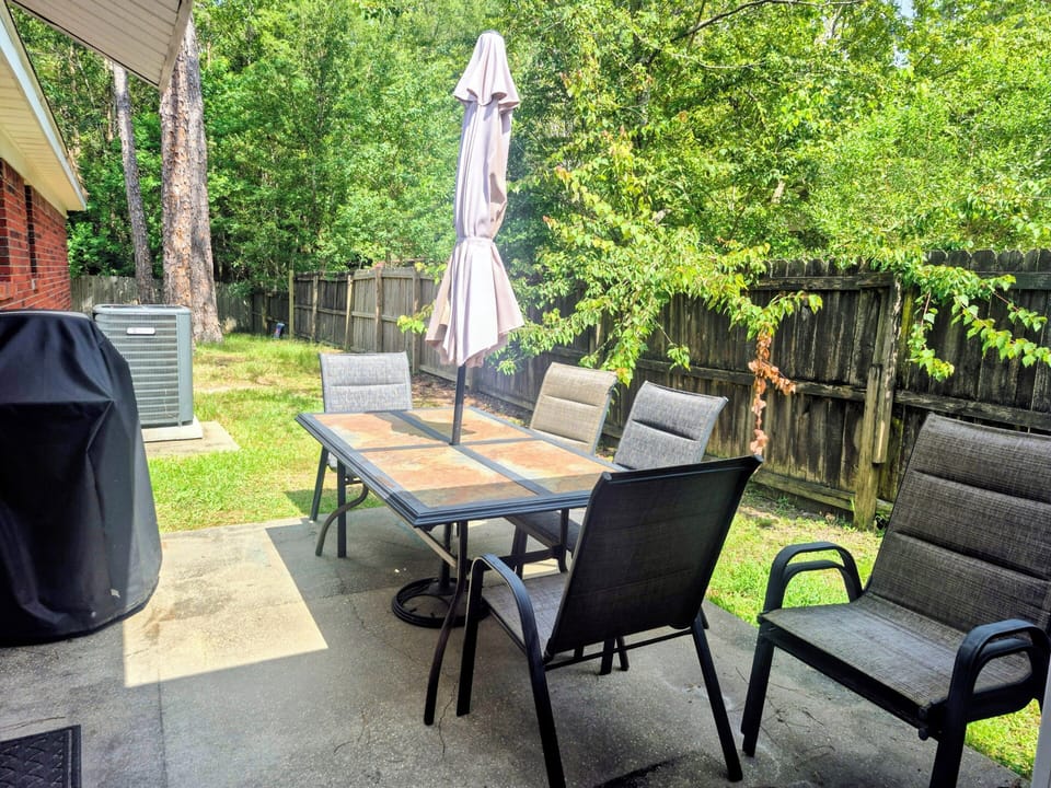 fenced back yard, summer, terrace patio, grill, outdoor, dining table.  