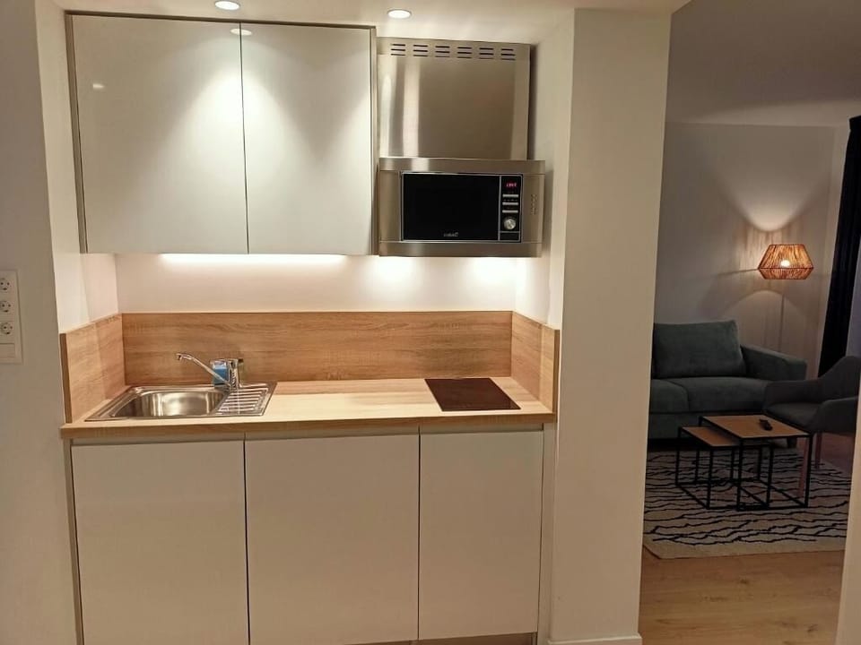Cook simple favorites in the sleek kitchenette with modern appliances