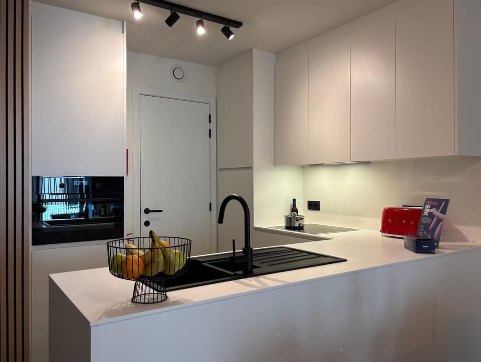 Modern white kitchen with full amenities for easy home cooking