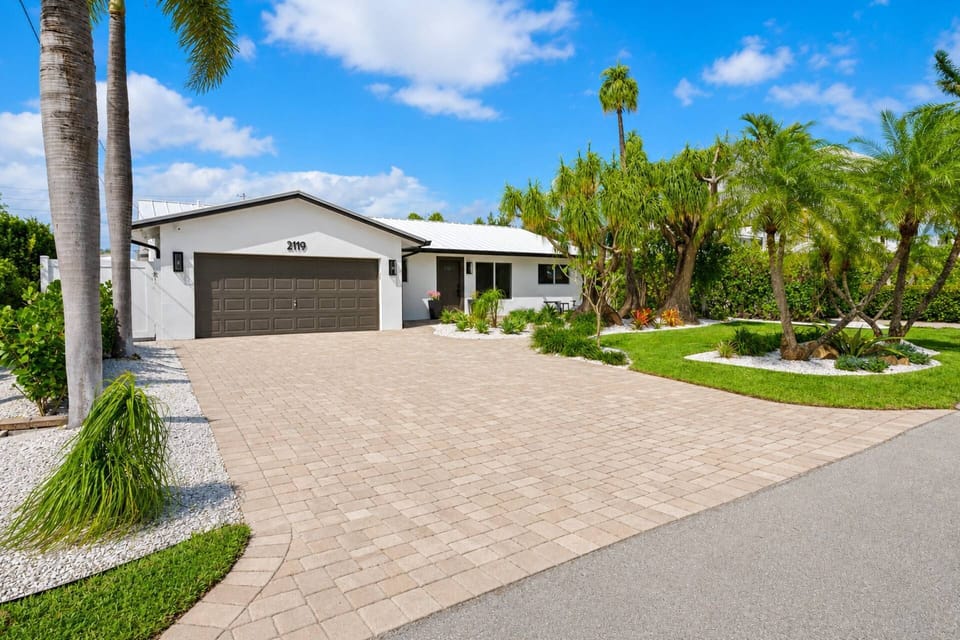 Beautifully remodeled exterior with ample parking, mature tropical landscaping, and exceptional curb appeal.