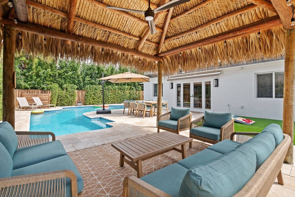 Comfortable outdoor seating area offering a seamless indoor-outdoor living experience overlooking the pool.