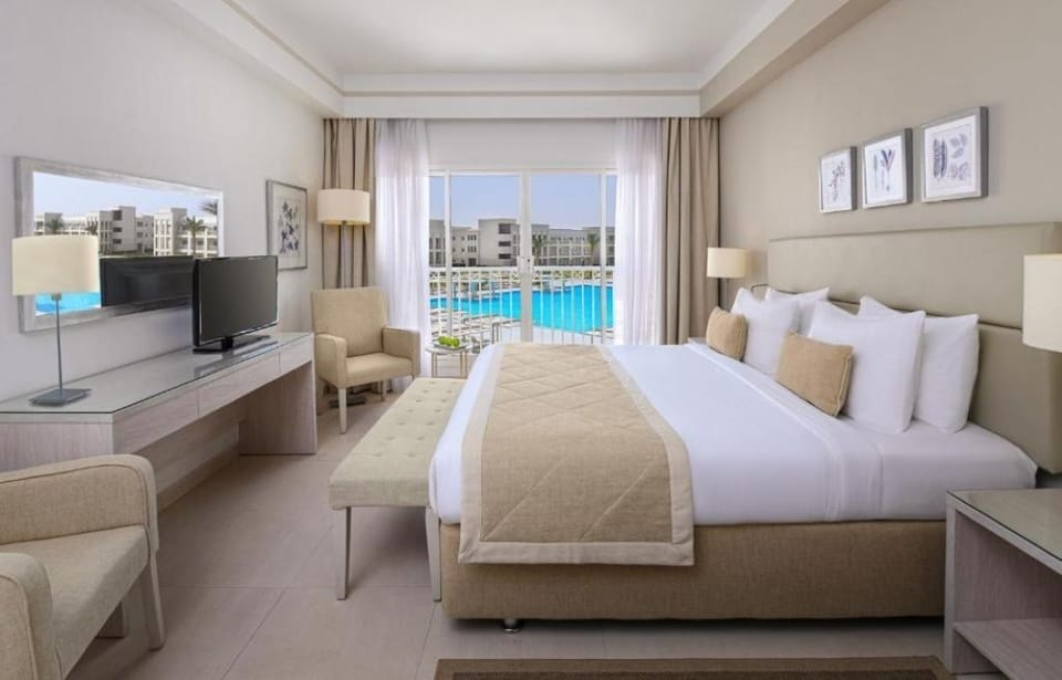 Wake up to balcony views and a bright, airy king bed.