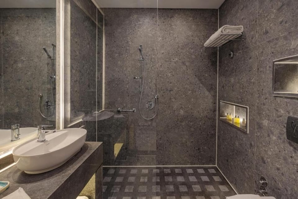 Refresh under a sleek rain shower in a spa-like bath.