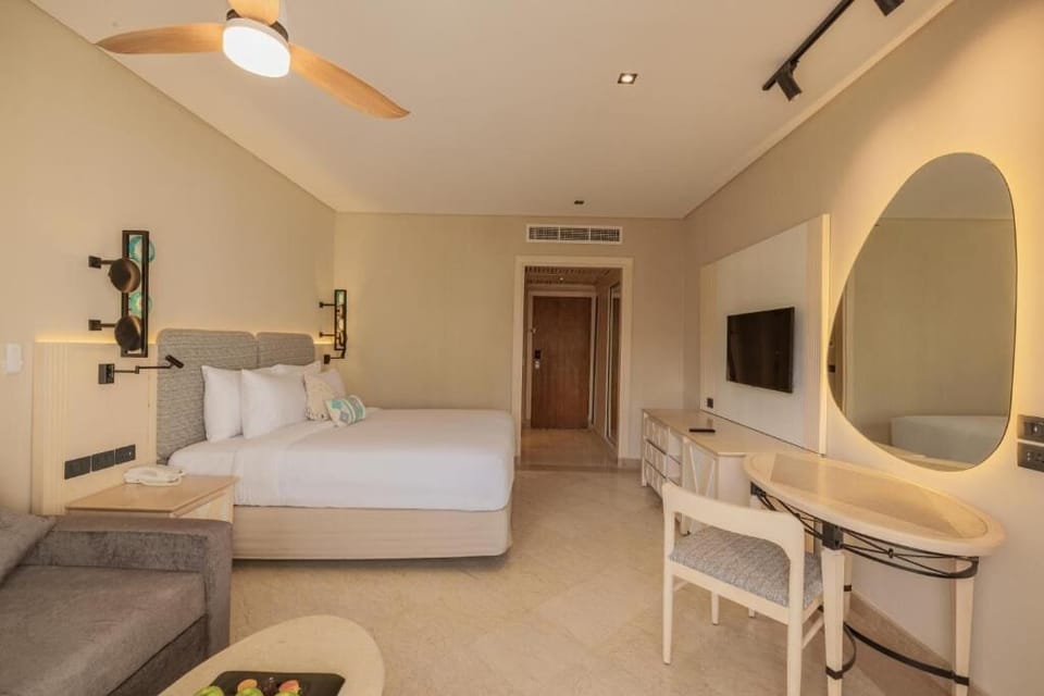 Settle in with spacious comfort, big TV, and elegant vanity.