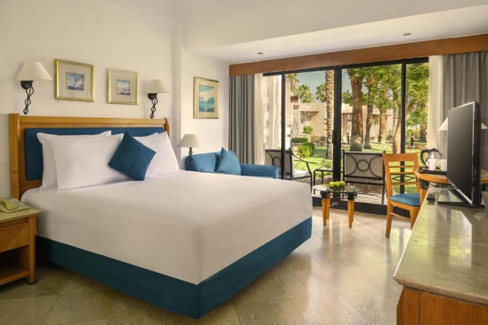 Sink into plush bedding and gaze out to lush gardens.