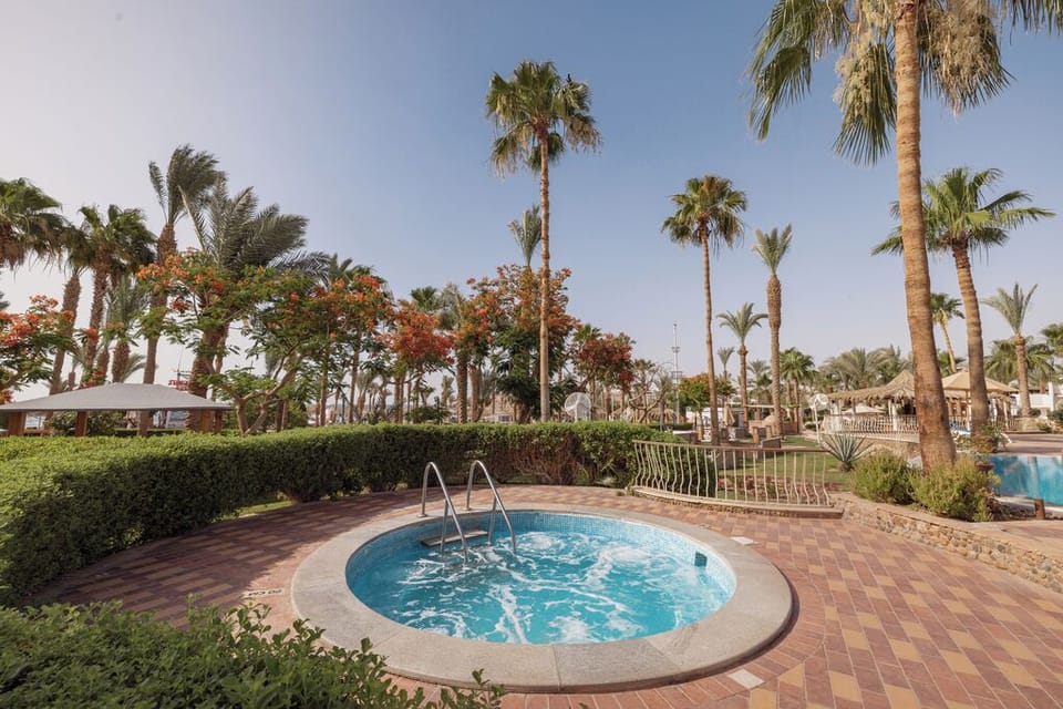 Soothe tired muscles in the bubbling hot tub under palms.