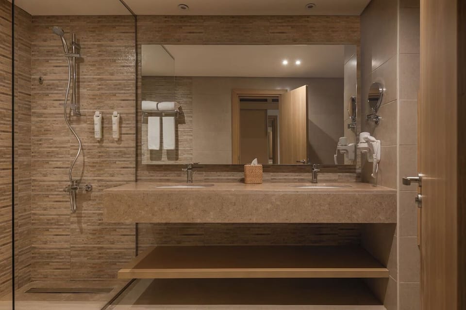 Rinse off in a sleek walk-in shower, spa-like calm.