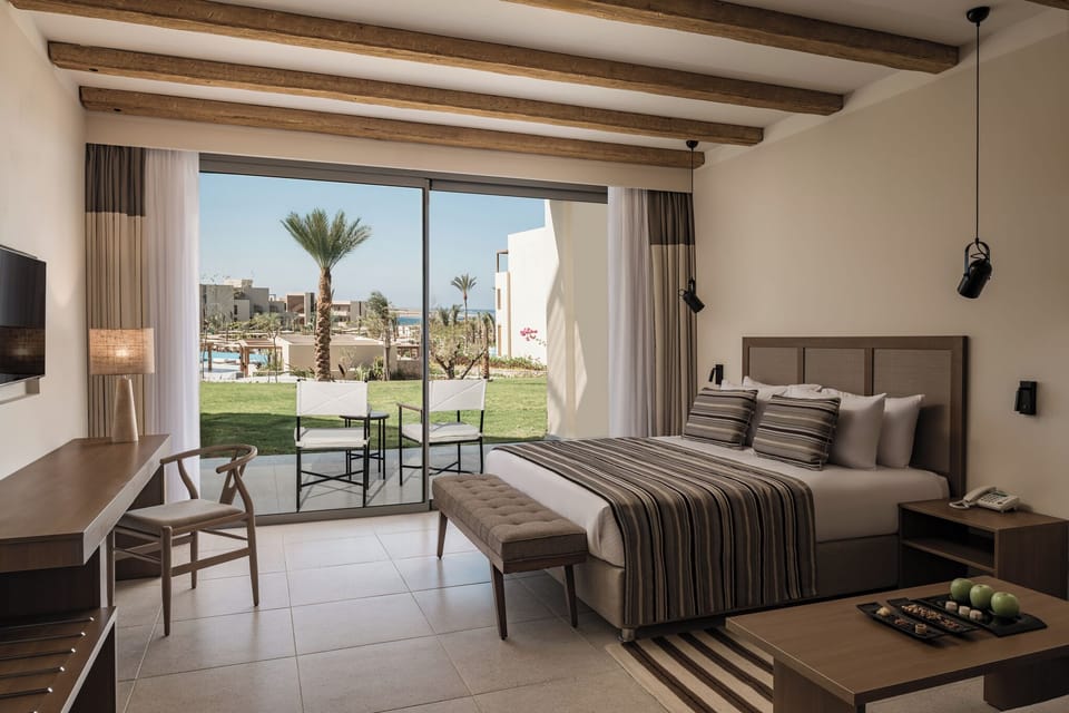 Soak up garden vistas from bed with sunlight streaming in.