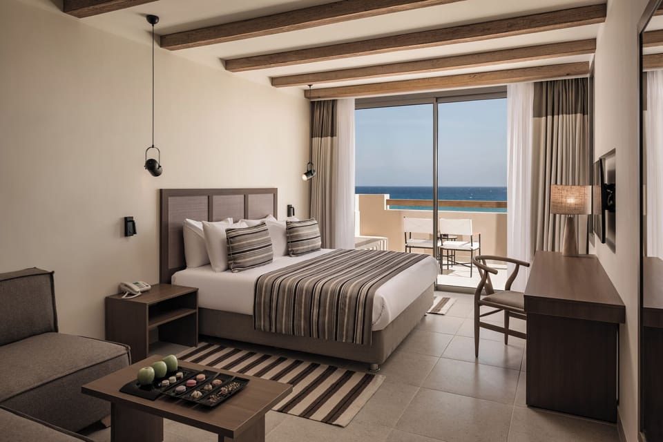 Unwind in crisp linens with soothing ocean-view balcony.