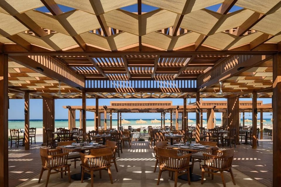 Savor ocean-breeze dining under shaded pergolas by the sea