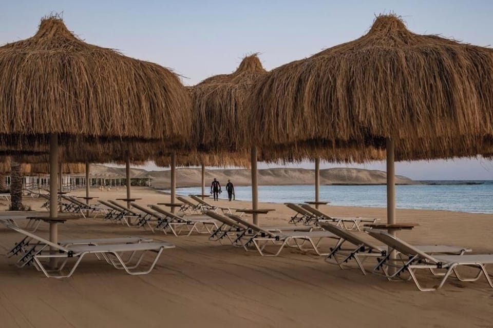 Watch kids giggle on the playground beside sparkling pools.