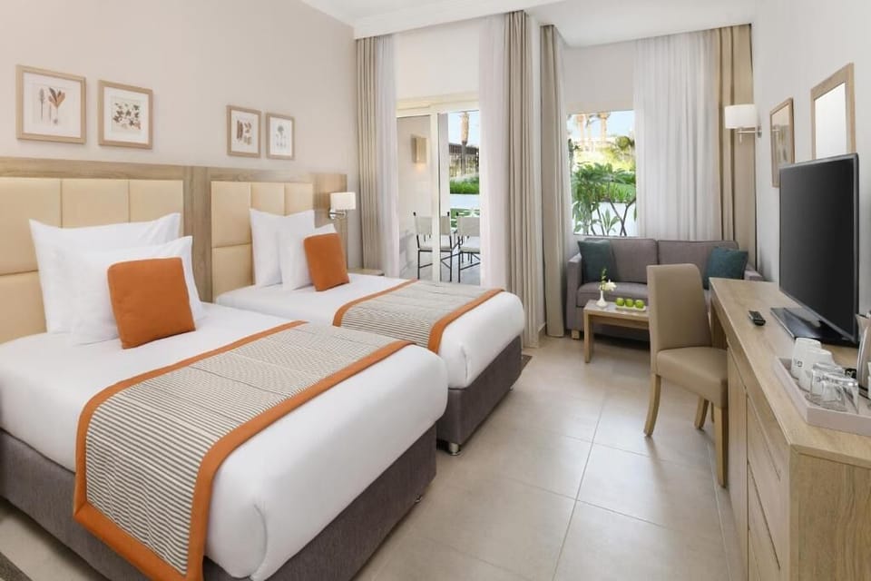 Recharge in a bright twin room with a cozy sitting nook.
