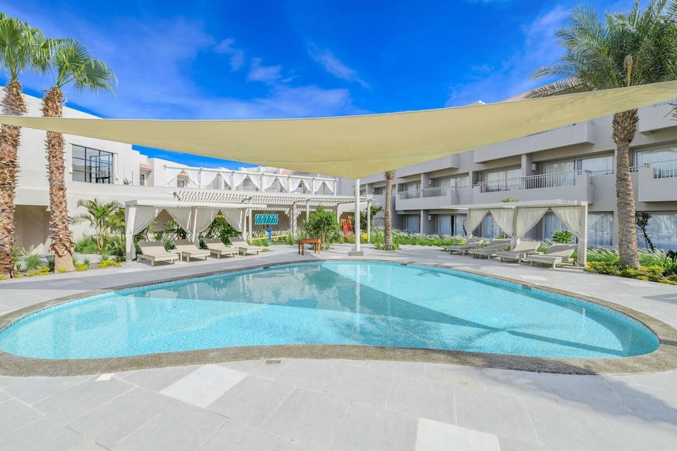 Cool off in the shaded courtyard pool, perfect for midday breaks.