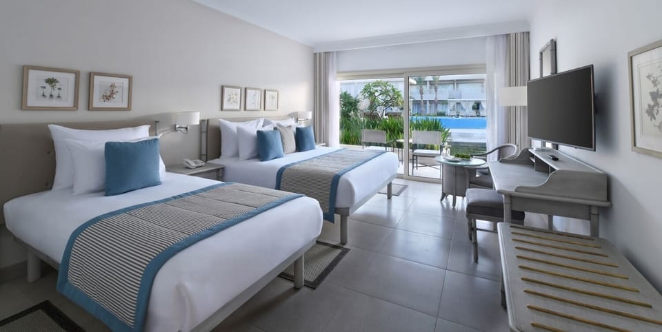 Savor poolside views from bed with airy, modern comfort.